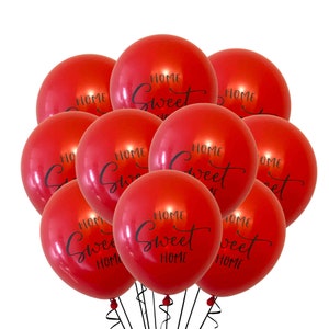 May include: A bunch of red balloons with the text "Home Sweet Home" printed on them.