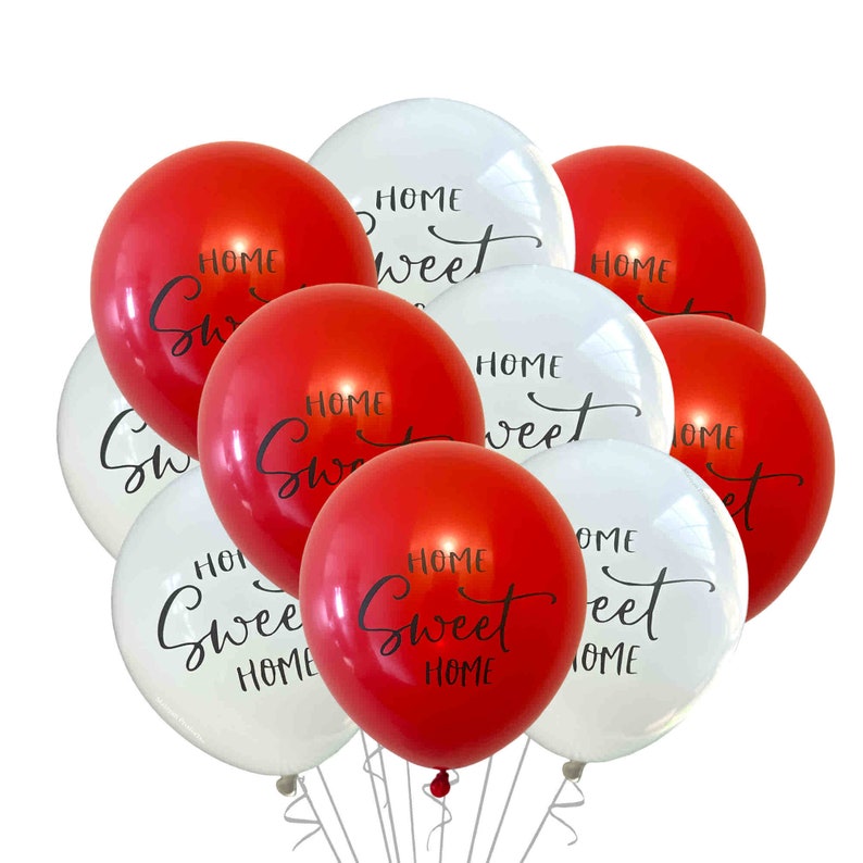 May include: A group of red and white balloons with the text "Home Sweet Home" printed on them.