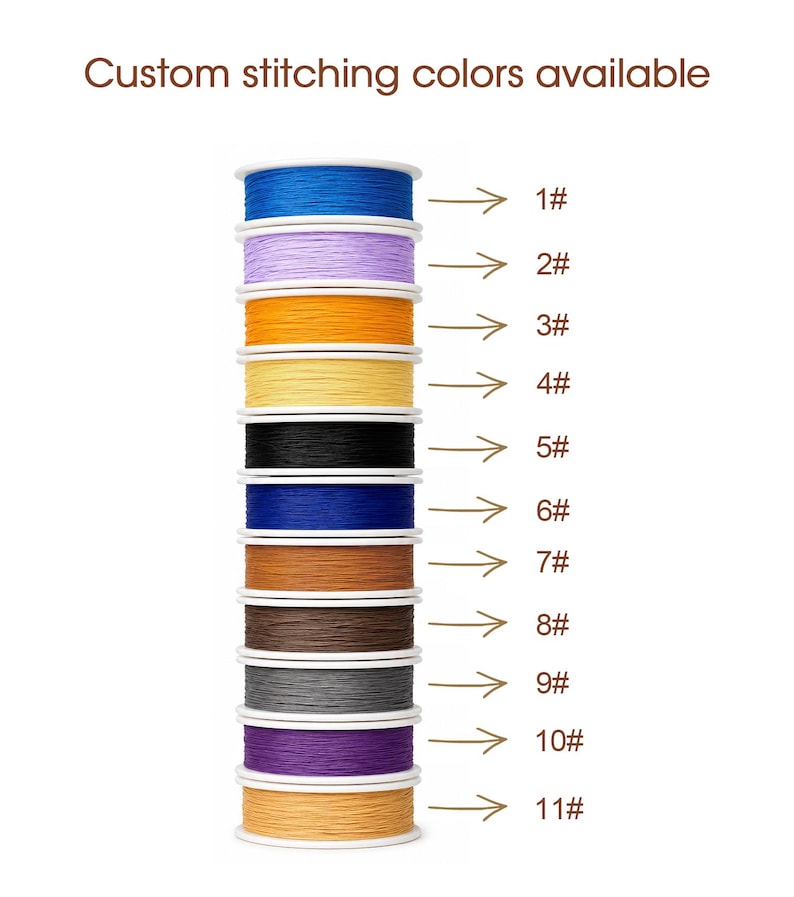 May include: A vertical stack of eleven spools of thread in various colors, including blue, lavender, orange, yellow, black, dark blue, brown, dark brown, gray, purple, and tan. The text Custom stitching colors available is at the top.