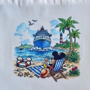 May include: White tote bag featuring a colorful illustration of Mickey Mouse relaxing on a beach. The scene includes a cruise ship, lighthouse, palm trees, and a life preserver. Mickey is in a beach chair with a drink.