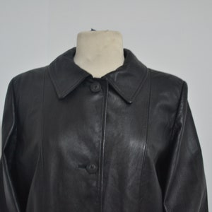 May include: A black leather jacket with a collared neckline and button closure.