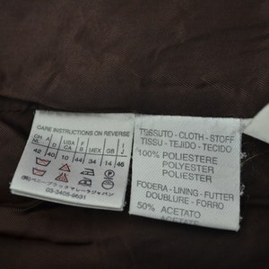 K&ouml;nnte beinhalten: Pflegehinweise auf der R&uuml;ckseite, Gr&ouml;&szlig;entabelle in Zoll, Stoffzusammensetzung: 100 % Polyester, Futter: 50 % Acetat.  TESSUTO-CLOTH-STOFF TISSU-TEJIDO-TECIDO 100% POLIESTERE POLYESTER POLIESTER FODERA-LINING-FUTTER DOUBLURE-FORRO 50% ACETATO ACETATE
