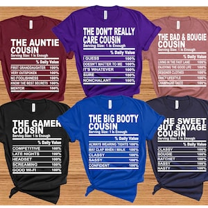 May include: Six different t-shirt designs with a nutrition label style graphic. Each shirt has a different title and description. The titles are "The Auntie Cousin", "The Don't Really Care Cousin", "The Bad & Bougie Cousin", "The Gamer Cousin", "The Big Booty Cousin", and "The Sweet But Savage Cousin".