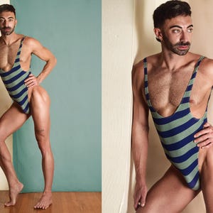 May include: A one-piece swimsuit with a high-cut leg design. The swimsuit features alternating horizontal stripes of blue and green. The model is standing in front of a wall with a teal background.