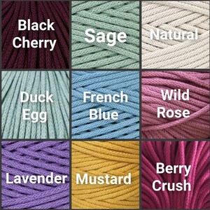 May include: A color palette of nine macrame cord samples. Colors include Black Cherry, Sage, Natural, Duck Egg, French Blue, Wild Rose, Lavender, Mustard, and Berry Crush. Each color is labeled with its name in white text.