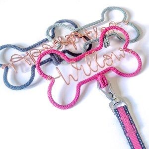 May include: Three dog leash hangers in the shape of a bone. The top showing a selection of dog bone shaped wire, french knit cord covered dog lead hook. These can be personalised with your pets name in copper wire.