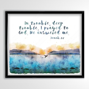 May include: Watercolor art print in a black frame. The artwork depicts a seascape with mountains, a whale's tail, and the text "In trouble, deep trouble, I prayed to God. He answered me. Jonah 2:2."