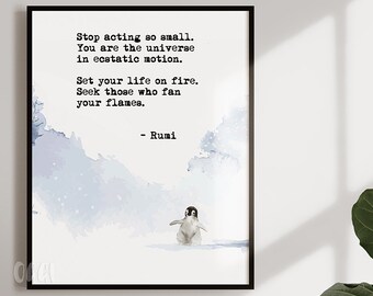 May include: A watercolor print with a quote by Rumi: "Stop acting so small. You are the universe in ecstatic motion. Set your life on fire. Seek those who fan your flames." The quote is printed in black text on a white background. A small penguin is walking on a snowy landscape in the bottom of the print.