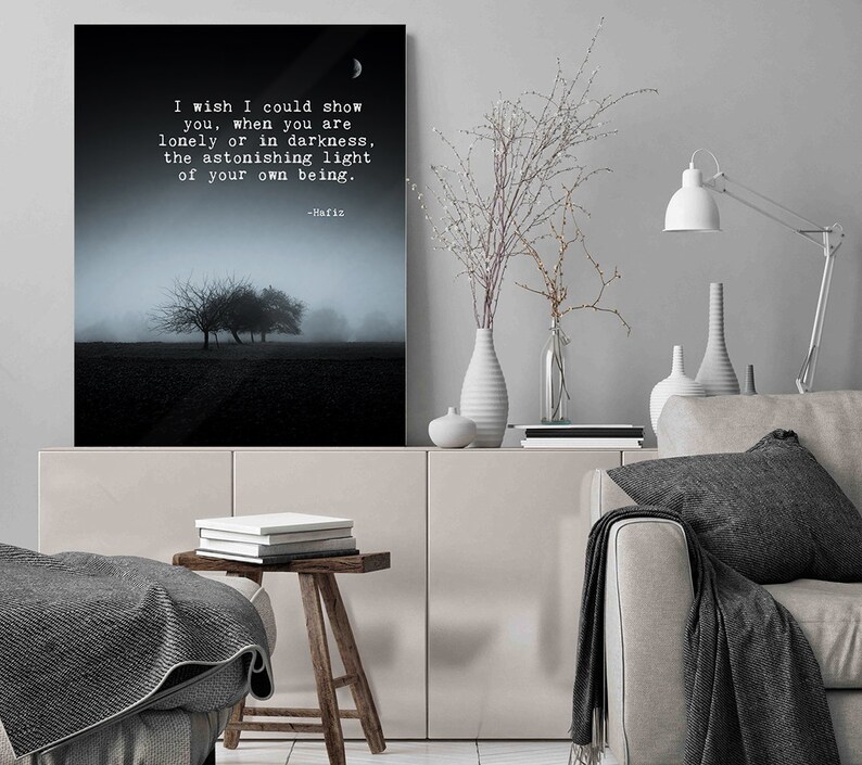 May include: A black and white photo of trees in a foggy field with a quote by Hafiz: "I wish I could show you, when you are lonely or in darkness, the astonishing light of your own being."