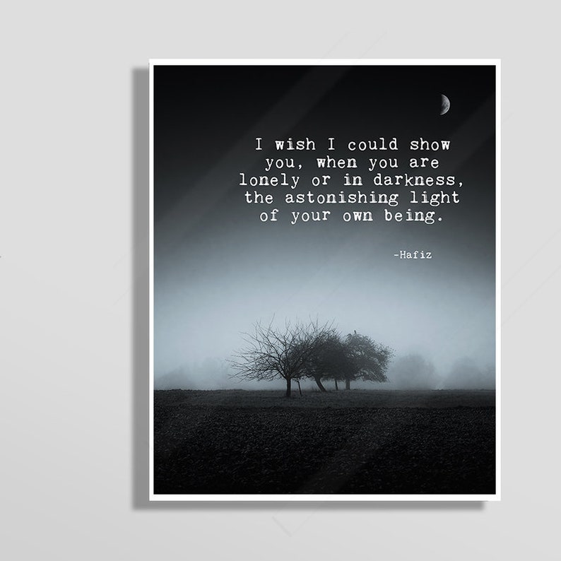 May include: A black and white image of a quote by Hafiz, a Persian poet, about finding light within yourself. The quote reads: "I wish I could show you, when you are lonely or in darkness, the astonishing light of your own being." The image features a dark, foggy landscape with trees in the distance.