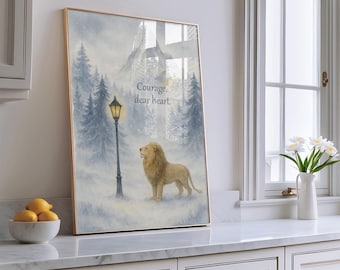 May include: Framed art print featuring a lion standing in a snowy landscape with a lamppost and evergreen trees. The artwork has a gold frame and includes the text "Courage, dear heart."