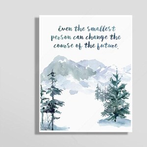 May include: Watercolor art print featuring a mountain landscape with evergreen trees in shades of blue and green. The print includes the quote, "Even the smallest person can change the course of the future."