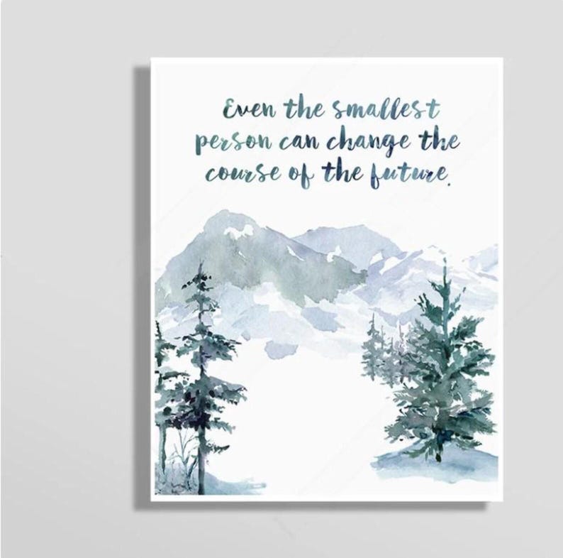 May include: Watercolor art print featuring a mountain landscape with evergreen trees in shades of blue and green. The print includes the quote, "Even the smallest person can change the course of the future."