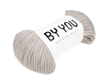 Op de afbeelding: Een rol beige katoenen koord met het label "BY YOU COTTON CORD".