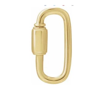 May include: A gold-colored, oval-shaped screw lock. The lock has a rectangular body with a rounded top and bottom, and a curved, elongated loop. The metal has a polished, reflective surface, suggesting a jewelry or accessory item.