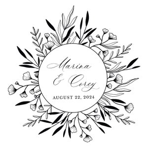 May include: Black and white illustration of a floral wreath with a circle in the center. The circle contains the text "Marina & Corey" and "August 22, 2024".