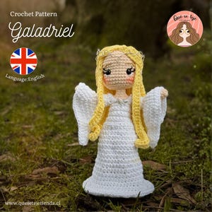 May include: A crocheted doll of Galadriel, with long yellow hair and a white dress. The doll has a delicate silver crown and is standing on a bed of green grass. The words "Crochet Pattern Galadriel" are at the top of the image.