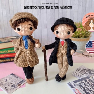 May include: Two crocheted dolls representing Sherlock Holmes and Dr. Watson. Sherlock wears a brown coat and hat, while Dr. Watson has a black coat and bowler hat. The dolls are handmade, with detailed outfits and facial features. The text "SHERLOCK HOLMES & DR. WATSON" is visible.