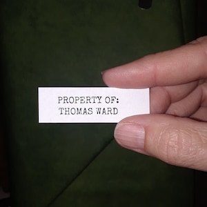 May include: A white label with black text that reads "PROPERTY OF: THOMAS WARD".
