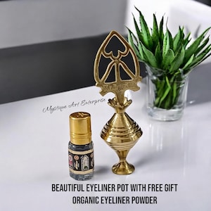 May include: A gold metal eyeliner pot with a decorative top and a small glass bottle of black eyeliner powder. The text "BEAUTIFUL EYELINER POT WITH FREE GIFT ORGANIC EYELINER POWDER" is printed below the items.