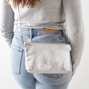 women wearing a silver leather crossbody bag