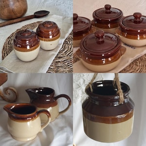 May include: A selection of vintage brown and cream ceramic kitchen items. The image shows salt and pepper shakers, lidded pots, jugs, and a hanging planter. Each piece has a two-tone design and a glossy finish.