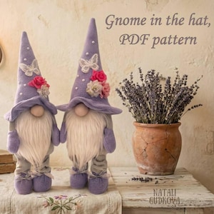 May include: Two handcrafted gnome figures with long white beards, wearing lavender hats decorated with butterflies, flowers, and white beads. The gnomes are holding hands. The image includes text that reads "Gnome in the hat, PDF pattern."