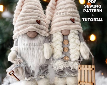 May include: A PDF sewing pattern and tutorial for making Scandinavian gnomes. The pattern includes two gnomes, one with a pink hat and the other with a white hat. Both gnomes are wearing gray pants and have white beards. The gnomes are standing on a snowy surface with a wooden sled in the background.