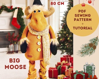 May include: A brown plush moose with a knitted scarf and a brown coat. The moose is standing on a white surface and is 80 cm tall. The text "BIG MOOSE" is in the lower left corner of the image. The text "HEIGHT 80 CM" is in the upper right corner of the image. The text "PDF SEWING PATTERN + TUTORIAL" is in the upper right corner of the image.
