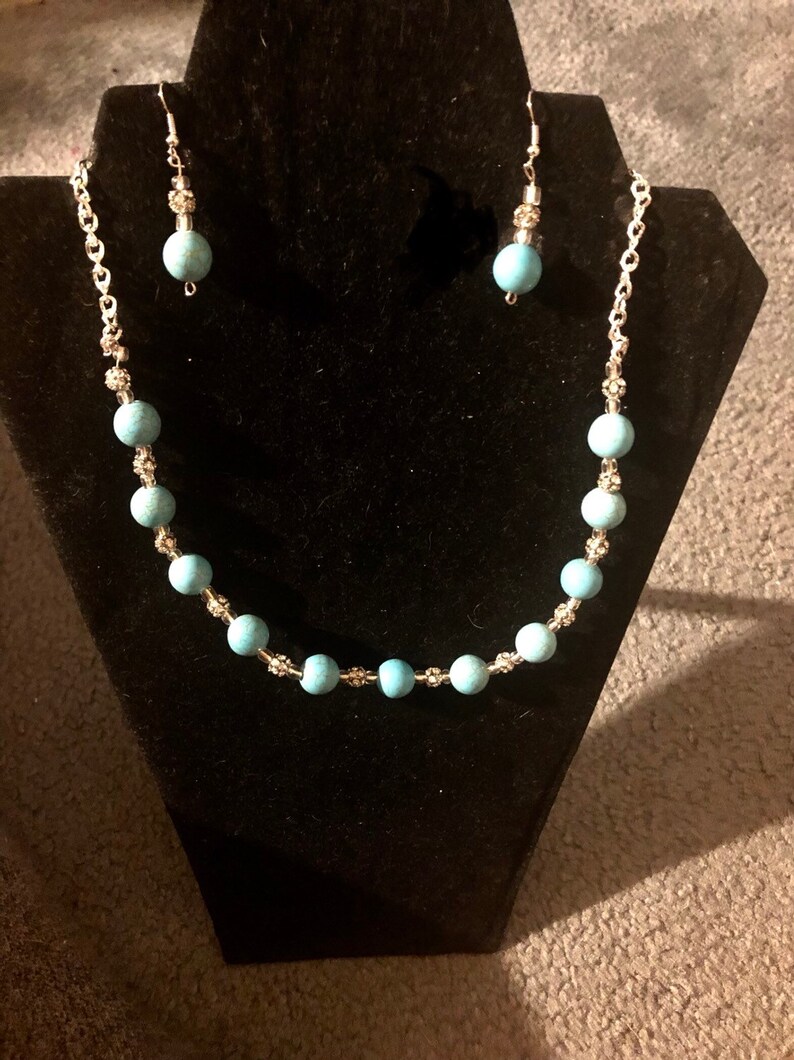 Turquoise necklace and earring set with silver accents