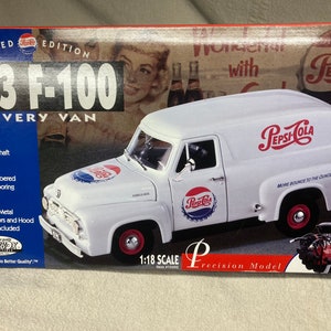 May include: A white 1953 Ford F-100 delivery van model with a Pepsi-Cola logo on the side. The model is 1:18 scale and features a detailed interior, functional drive shaft, steerable wheels, and a tilting seat. The box also includes a display stand.
