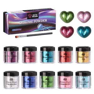 May include: A collection of chrome powder jars in various colors, including purple, rose red, blue, red, gold, holographic silver, royal blue, green, holographic pink, and light blue. The image also shows a box of chrome powder, a brush, and heart-shaped decorations.
