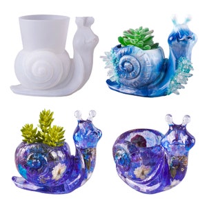 May include: Four snail-shaped planters, two are blue with white and gold accents, one is white, and one is blue with purple and white accents. The blue planters have small plants growing in them.
