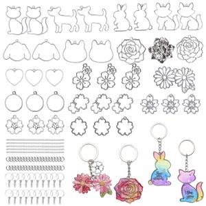May include: A collection of metal charms and keychains in various shapes, including animals, flowers, and hearts. The keychains feature colorful, iridescent designs. Includes key rings and chains for crafting or jewelry making.