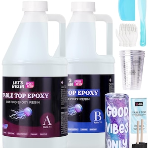 May include: Two clear plastic bottles of epoxy resin labeled "Table Top Epoxy" and "Top Epoxy" with a 1:1 ratio. The bottles are next to a tumbler with a galaxy design and the words "Good Vibes Only". The image also includes a set of measuring cups, a pair of gloves, two spatulas, and two paint brushes.