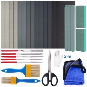 May include: A set of 10 sanding files in various grits, a pair of scissors, two paint brushes, and a blue microfiber cloth. The sanding files are labeled "x 10".