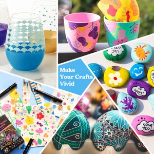May include: A collection of craft supplies including paint markers, paint pens, and blank canvases. The image also shows painted rocks with various designs and phrases like "Read Joy!" and "Be Happy!"