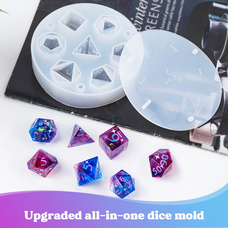 May include: A set of seven clear silicone molds for making dice, with a set of seven iridescent dice with pink and blue glitter. The molds are labeled with numbers 1-6 and the dice are also numbered.