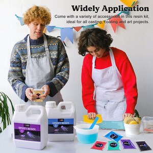 May include: Two people wearing aprons are working with epoxy resin. The resin is in two clear plastic bottles labeled "Epoxy Resin A" and "Epoxy Resin B". There are also six small containers of colorful pigments.