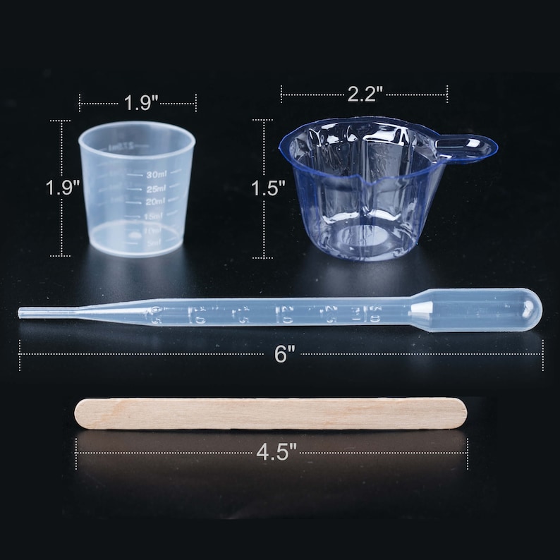 May include: A set of four clear plastic measuring tools for crafting and resin art. The set includes a 1.9-inch diameter measuring cup, a 2.2-inch diameter measuring cup with a handle, a 6-inch long plastic dropper, and a 4.5-inch long wooden mixing stick.