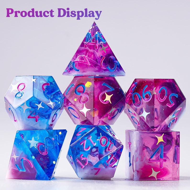 May include: Set of seven polyhedral dice with a galaxy theme. The dice are made of clear resin with swirls of pink and blue, and glitter embedded throughout. The numbers are printed in white.