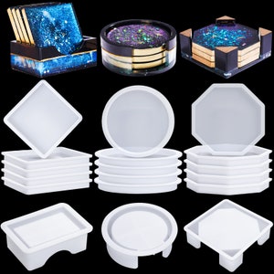 May include: Set of 10 silicone molds for making coasters. The molds are in various shapes, including square, round, octagon, and a unique shape with a raised edge. The molds are white and made of flexible silicone.