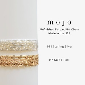 May include: Two stacked chain necklaces, one silver and one gold. The silver chain is 925 Sterling Silver and the gold chain is 14K Gold Filled. The chains are both unfinished dapped bar chains, made in the USA. The text "mojo" is at the top of the image.