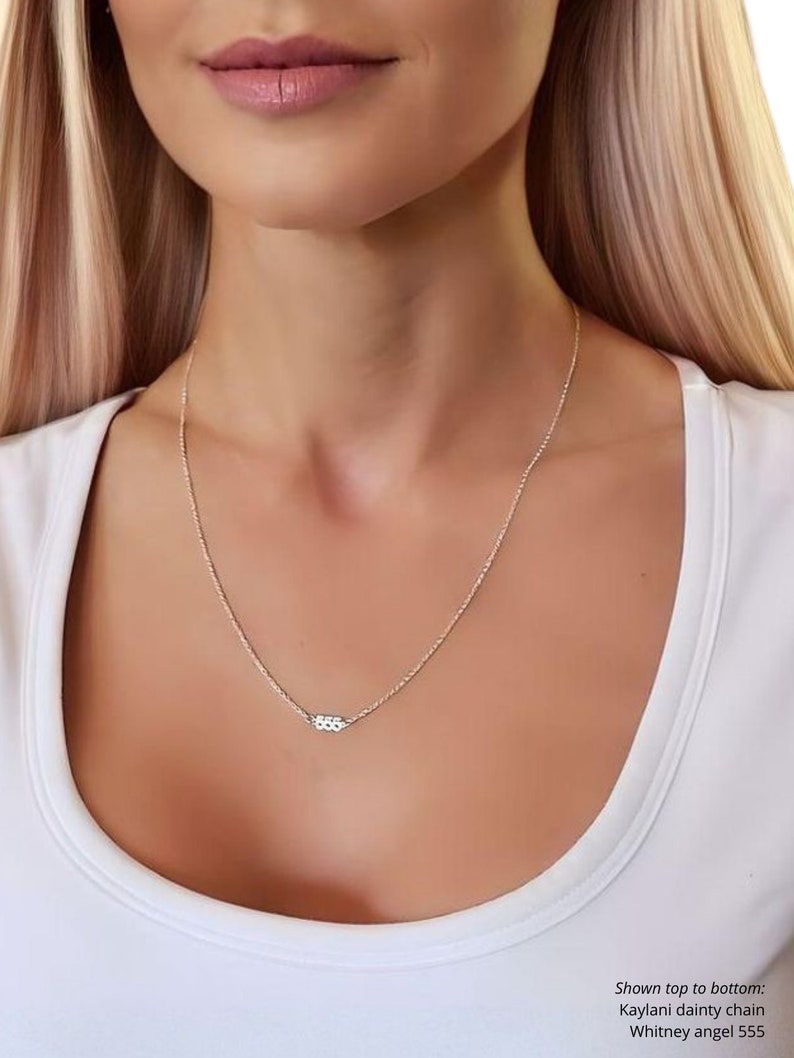 May include: A silver chain necklace with a small silver charm that says "555". Shown top to bottom: Kaylani dainty chain, Whitney angel 555.
