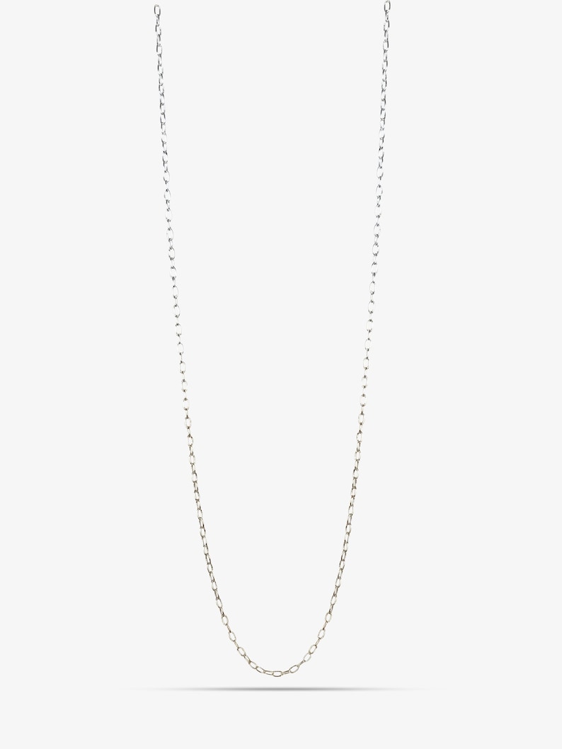 May include: A long, slender silver chain necklace featuring a series of small, uniform oval-shaped links connected in a continuous loop. The metallic surface has a polished finish that reflects light, creating a bright and clean appearance.