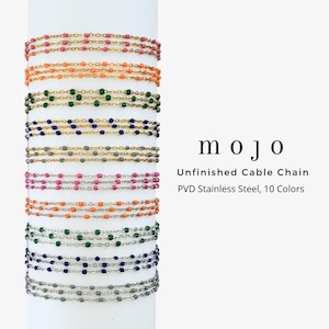 May include: A collection of unfinished cable chains in ten colors, featuring small beads along the links. The text reads: mojo, Unfinished Cable Chain, PVD Stainless Steel, 10 Colors. The chains are displayed vertically on a white cylindrical post.