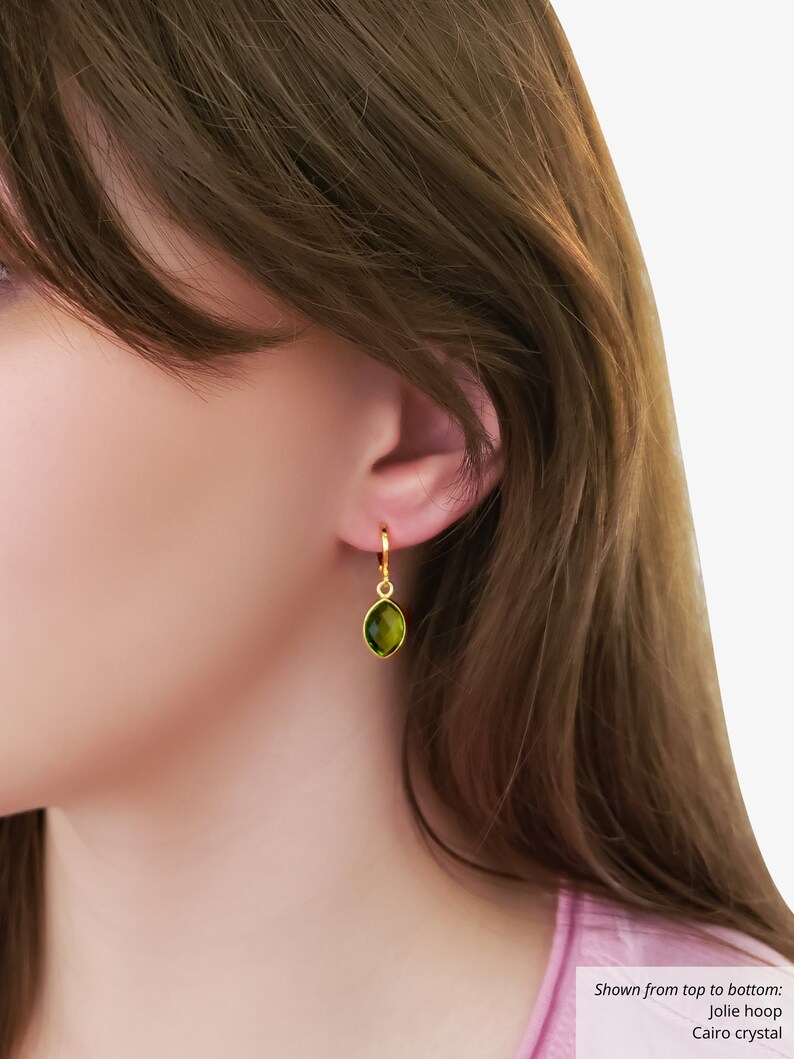 May include: Gold hoop earrings with a green gemstone pendant. Shown from top to bottom: Jolie hoop, Cairo crystal.