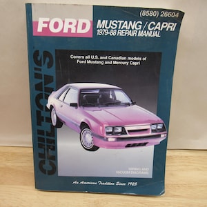 May include: A Chilton's repair manual for Ford Mustang and Capri models from 1979-88. The cover features a pink car illustration and the Ford logo. Includes wiring and vacuum diagrams. "An American Tradition Since 1925" is printed at the bottom.
