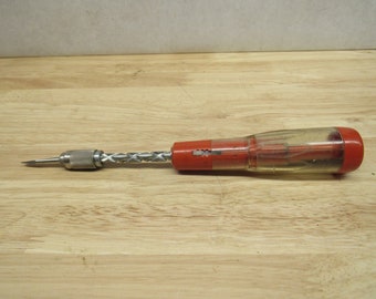 May include: A red and clear plastic screwdriver with a metal shaft and a variety of interchangeable bits.