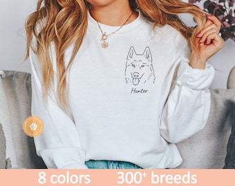 Op de afbeelding: Witte longsleeve sweatshirt met een zwarte lijntekening van een hondenkop en de naam "Hunter" eronder gedrukt. De sweatshirt is verkrijgbaar in 8 kleuren en meer dan 300 rassen.